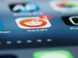 Detailed close-up of a smartphone screen showing the Reddit app with a notification badge.